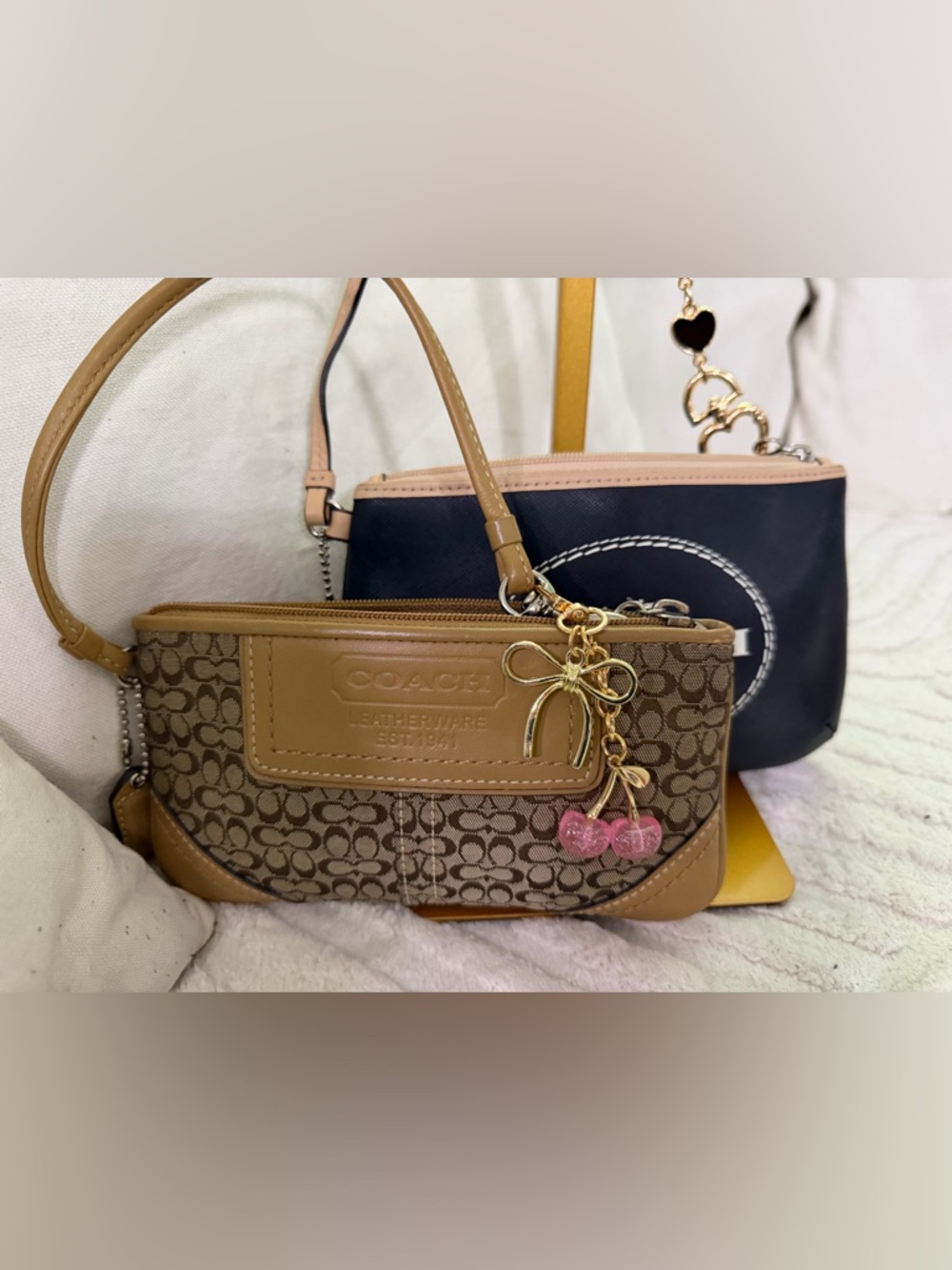 Coach Brown Signature Canvas Wristlet with Pink Cherry Charm and black wristlet